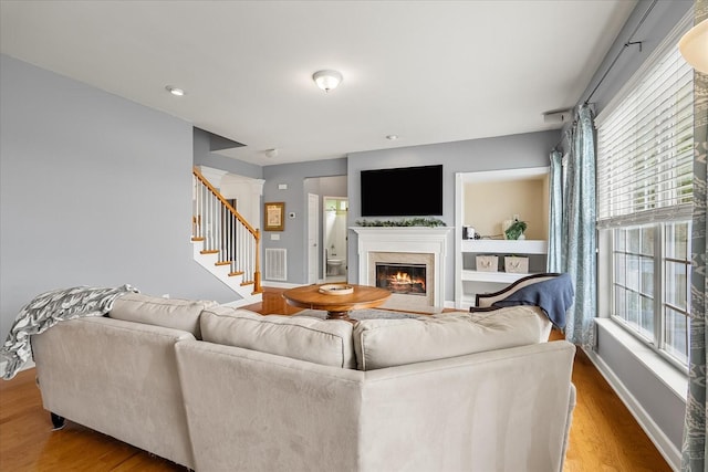 4055 Williford Way, Spring Hill, TN 37174 - living room with wood finished floors, a fireplace, stairs, and baseboards