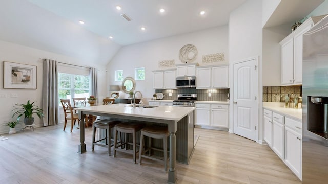 3632 Stormy Ln, Rockvale, TN 37153 - kitchen featuring stainless steel appliances, a sink, a kitchen island with sink, light wood-style floors, and light countertops