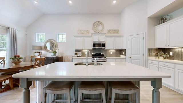 3632 Stormy Ln, Rockvale, TN 37153 - kitchen featuring stainless steel appliances, a sink, a breakfast bar, tasteful backsplash, and recessed lighting