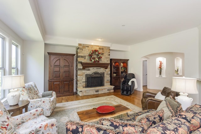 1414 Bernard Way, Franklin, TN 37067 - living area featuring a stone fireplace, wood finished floors, crown molding, and arched walkways