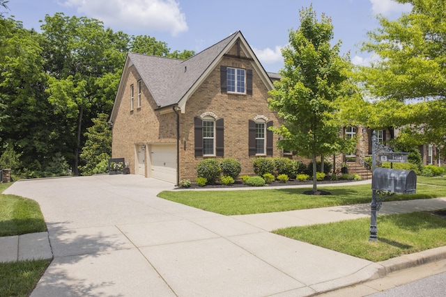 1414 Bernard Way, Franklin, TN 37067 - view of front of home with an attached garage, concrete driveway, a front lawn, and brick siding