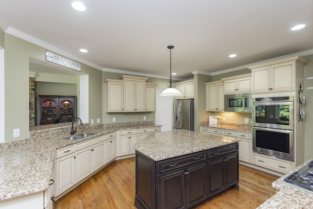 1414 Bernard Way, Franklin, TN 37067 - kitchen featuring a sink, stainless steel appliances, cream cabinets, crown molding, and light wood-type flooring