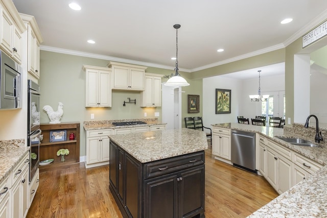 1414 Bernard Way, Franklin, TN 37067 - kitchen with a sink, appliances with stainless steel finishes, light wood finished floors, decorative light fixtures, and ornamental molding