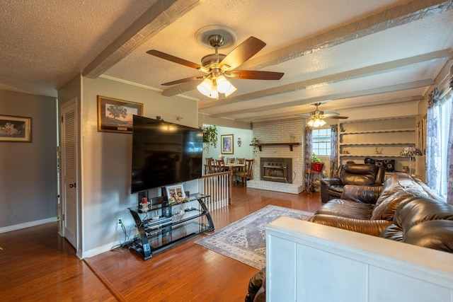 711 Hurricane Hill Dr, Waynesboro, TN 38485 - living area featuring beamed ceiling, a textured ceiling, ceiling fan, wood finished floors, and baseboards