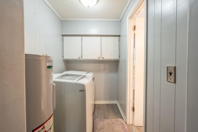 711 Hurricane Hill Dr, Waynesboro, TN 38485 - laundry room featuring independent washer and dryer, water heater, light wood-style flooring, ornamental molding, and cabinet space