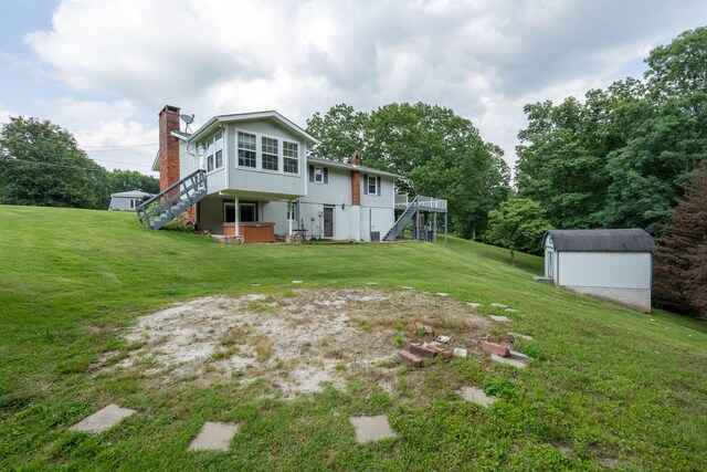 711 Hurricane Hill Dr, Waynesboro, TN 38485 - rear view of property with stairway, a chimney, a lawn, a wooden deck, and a covered hot tub