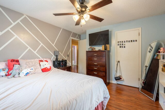 711 Hurricane Hill Dr, Waynesboro, TN 38485 - bedroom with wood finished floors, ceiling fan, and a textured ceiling