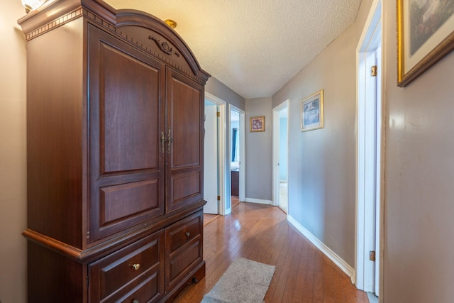 711 Hurricane Hill Dr, Waynesboro, TN 38485 - hallway with wood-type flooring, baseboards, and a textured ceiling