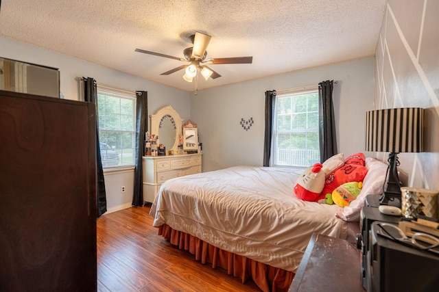 711 Hurricane Hill Dr, Waynesboro, TN 38485 - bedroom featuring wood finished floors, multiple windows, a textured ceiling, and a ceiling fan