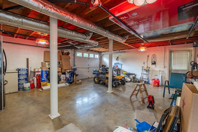 711 Hurricane Hill Dr, Waynesboro, TN 38485 - garage with stainless steel fridge and concrete block wall