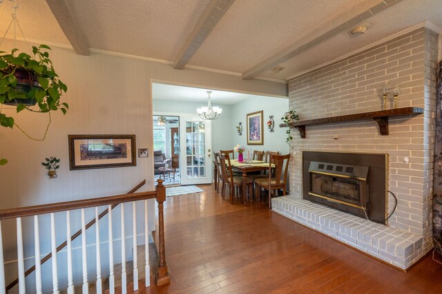 711 Hurricane Hill Dr, Waynesboro, TN 38485 - living room featuring hardwood / wood-style floors, beam ceiling, a textured ceiling, and a chandelier