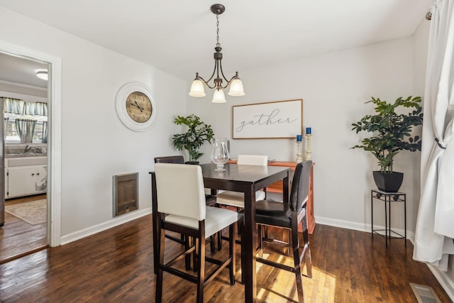 214 Glenn Ave, Gallatin, TN 37066 - dining room featuring wood finished floors, baseboards, a chandelier, and heating unit