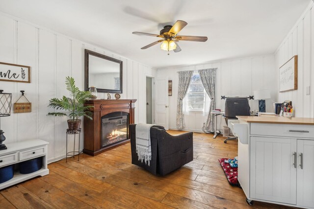 214 Glenn Ave, Gallatin, TN 37066 - living room featuring a ceiling fan, hardwood / wood-style flooring, a glass covered fireplace, an office area, and a decorative wall