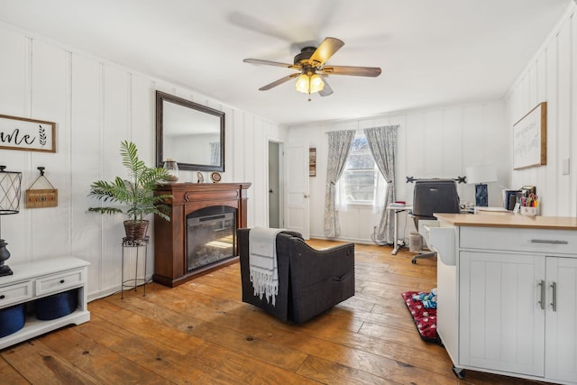 214 Glenn Ave, Gallatin, TN 37066 - living area with a ceiling fan, hardwood / wood-style floors, a glass covered fireplace, and a decorative wall