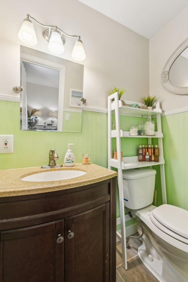 214 Glenn Ave, Gallatin, TN 37066 - bathroom with toilet, vanity, wainscoting, and tile patterned flooring