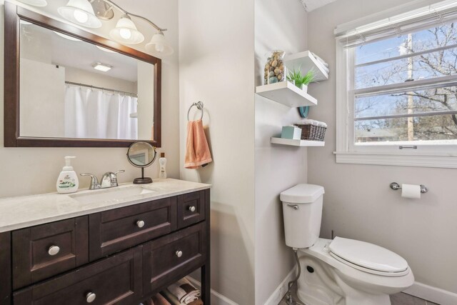 214 Glenn Ave, Gallatin, TN 37066 - bathroom with baseboards, toilet, and vanity