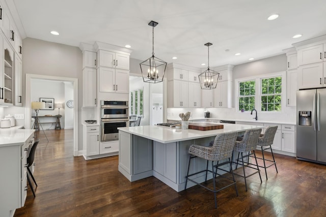 6795 Leipers Creek Rd, Columbia, TN 38401 - kitchen with stainless steel appliances, white cabinets, a kitchen island, a chandelier, and recessed lighting