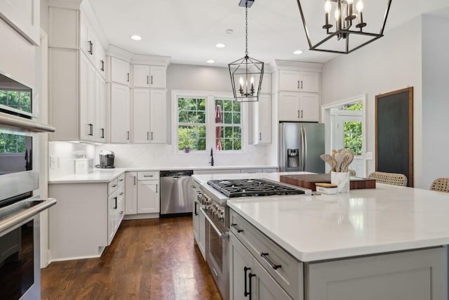 6795 Leipers Creek Rd, Columbia, TN 38401 - kitchen featuring appliances with stainless steel finishes, a chandelier, plenty of natural light, recessed lighting, and dark wood-style floors