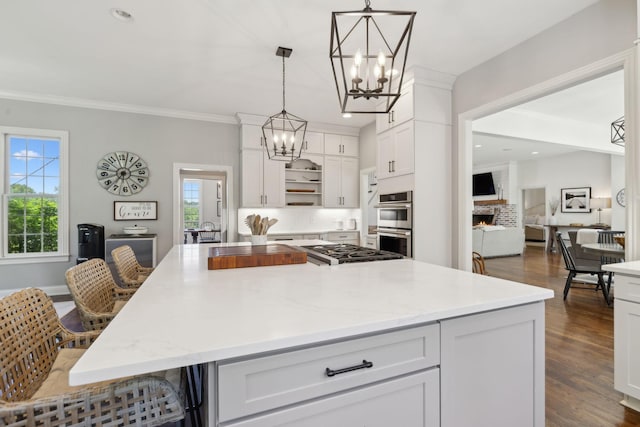 6795 Leipers Creek Rd, Columbia, TN 38401 - kitchen featuring stainless steel appliances, a chandelier, white cabinets, ornamental molding, and decorative light fixtures