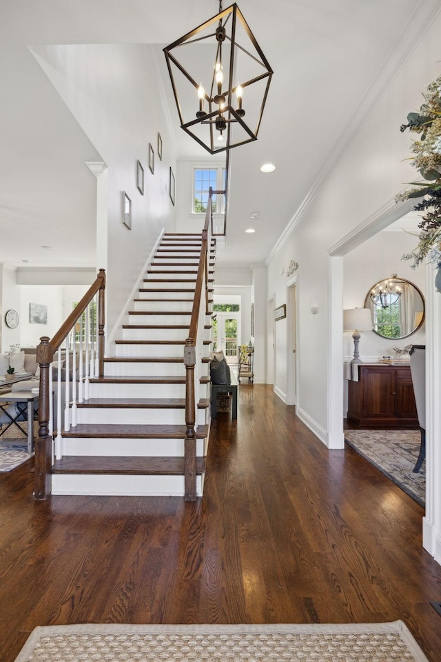 6795 Leipers Creek Rd, Columbia, TN 38401 - stairway featuring wood finished floors, a chandelier, crown molding, and baseboards
