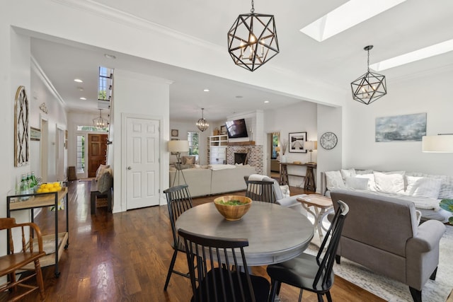 6795 Leipers Creek Rd, Columbia, TN 38401 - dining room featuring healthy amount of natural light, dark wood-type flooring, crown molding, a brick fireplace, and recessed lighting