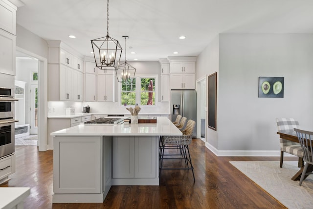 6795 Leipers Creek Rd, Columbia, TN 38401 - kitchen featuring stainless steel appliances, a chandelier, light countertops, white cabinets, and a kitchen island