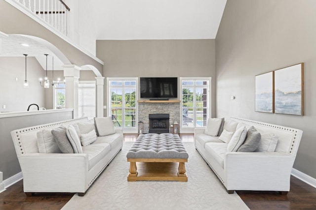 842 Shun Pike, Cottontown, TN 37048 - living room with a towering ceiling, wood finished floors, baseboards, arched walkways, and decorative columns
