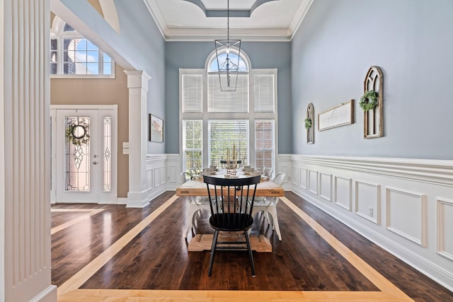 842 Shun Pike, Cottontown, TN 37048 - dining room featuring wood finished floors, crown molding, a wainscoted wall, a decorative wall, and a high ceiling