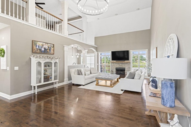 842 Shun Pike, Cottontown, TN 37048 - living area featuring a towering ceiling, a stone fireplace, baseboards, wood finished floors, and ceiling fan