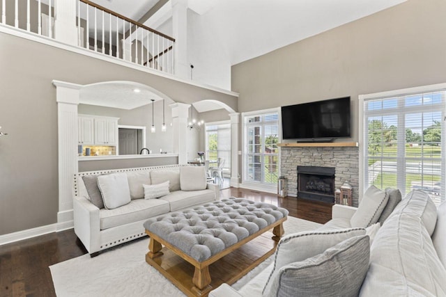 842 Shun Pike, Cottontown, TN 37048 - living area featuring a towering ceiling, arched walkways, baseboards, wood finished floors, and decorative columns