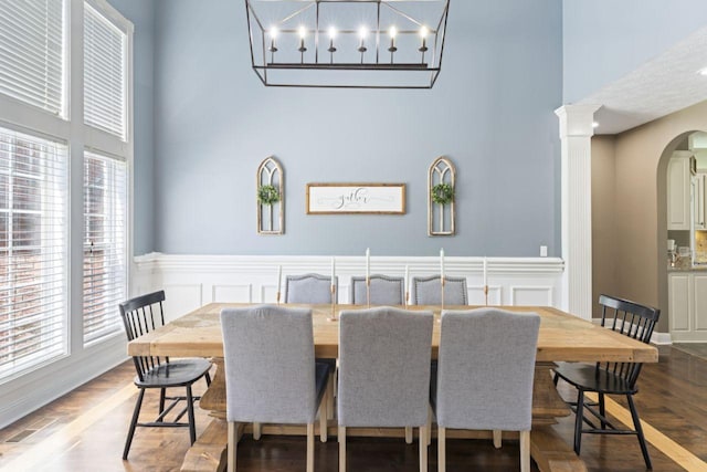 842 Shun Pike, Cottontown, TN 37048 - dining area featuring a towering ceiling, arched walkways, plenty of natural light, a decorative wall, and wainscoting