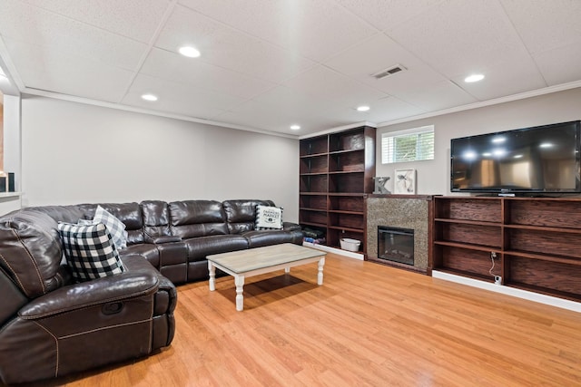 842 Shun Pike, Cottontown, TN 37048 - living area with wood finished floors, a glass covered fireplace, ornamental molding, recessed lighting, and a paneled ceiling