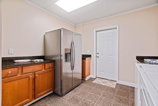 842 Shun Pike, Cottontown, TN 37048 - kitchen featuring stainless steel fridge with ice dispenser, crown molding, brown cabinetry, baseboards, and dark stone counters