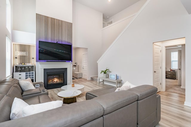120 Ravens Crest Ave, Mount Juliet, TN 37122 - living area featuring a high ceiling, light wood finished floors, and a glass covered fireplace