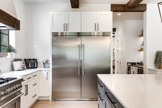 407 Hogans Branch Rd, Goodlettsville, TN 37072 - kitchen featuring high end appliances, white cabinets, decorative backsplash, light wood-style floors, and beam ceiling