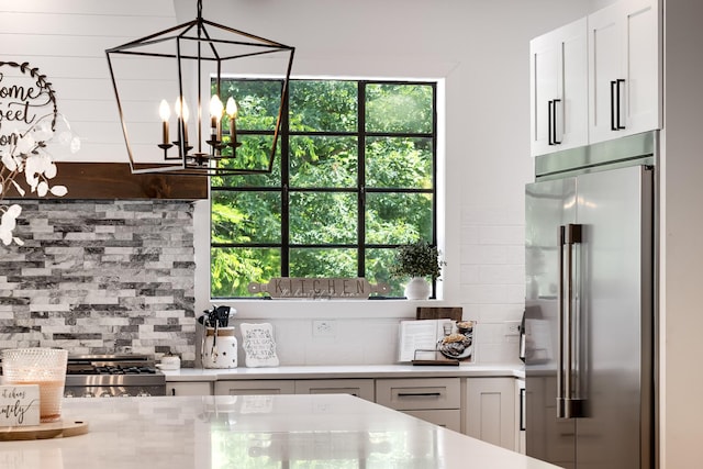407 Hogans Branch Rd, Goodlettsville, TN 37072 - kitchen with high end refrigerator, tasteful backsplash, light countertops, a chandelier, and white cabinets