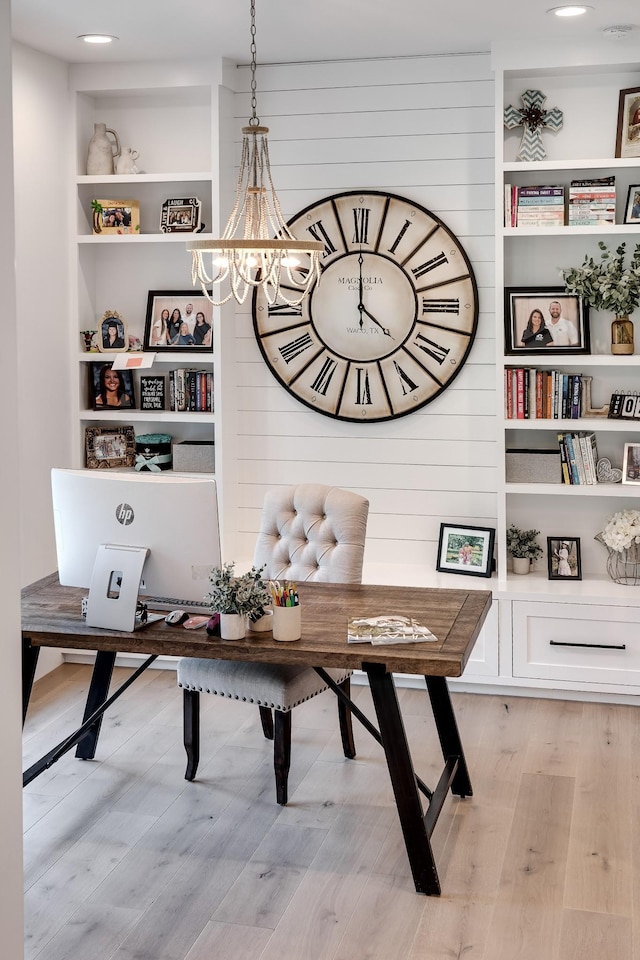 407 Hogans Branch Rd, Goodlettsville, TN 37072 - office area featuring a chandelier, light wood-type flooring, wooden walls, and built in shelves
