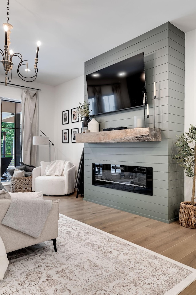 407 Hogans Branch Rd, Goodlettsville, TN 37072 - living area featuring a large fireplace, wood finished floors, and a chandelier