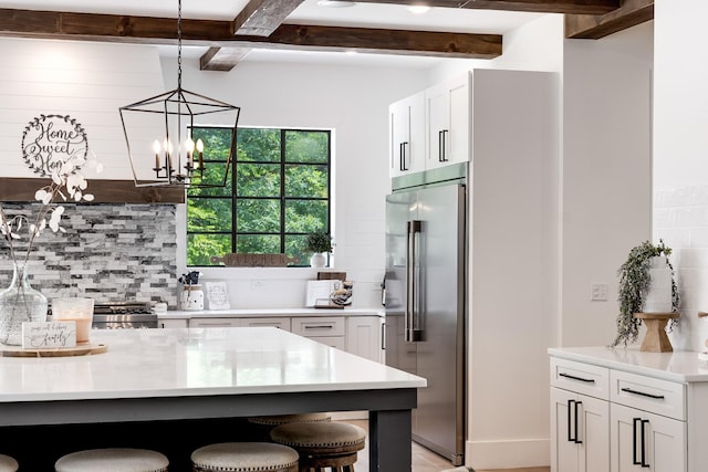 407 Hogans Branch Rd, Goodlettsville, TN 37072 - kitchen with high quality fridge, a breakfast bar, tasteful backsplash, light countertops, and beam ceiling