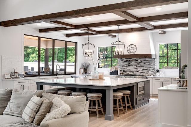 407 Hogans Branch Rd, Goodlettsville, TN 37072 - kitchen featuring backsplash, light wood-type flooring, open floor plan, plenty of natural light, and beam ceiling