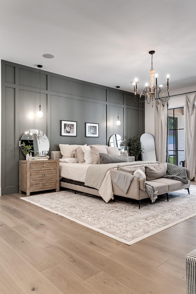 407 Hogans Branch Rd, Goodlettsville, TN 37072 - bedroom featuring a decorative wall, a chandelier, wood finished floors, and access to exterior