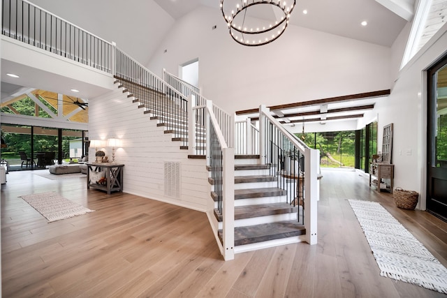 407 Hogans Branch Rd, Goodlettsville, TN 37072 - stairway with high vaulted ceiling, wood finished floors, a chandelier, and recessed lighting