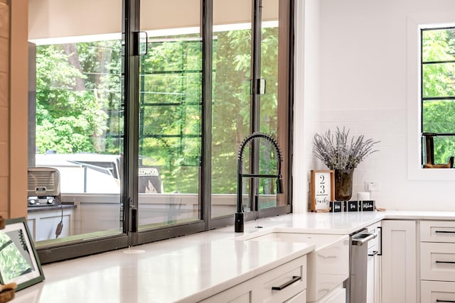 407 Hogans Branch Rd, Goodlettsville, TN 37072 - kitchen with a sink, white cabinetry, and light countertops