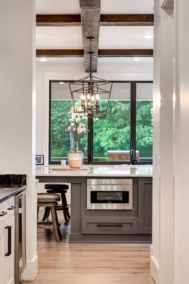 407 Hogans Branch Rd, Goodlettsville, TN 37072 - kitchen featuring stainless steel oven, light wood finished floors, beamed ceiling, beverage cooler, and a sink