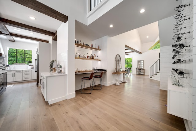 407 Hogans Branch Rd, Goodlettsville, TN 37072 - kitchen featuring light wood-style flooring, light countertops, white cabinetry, recessed lighting, and a towering ceiling