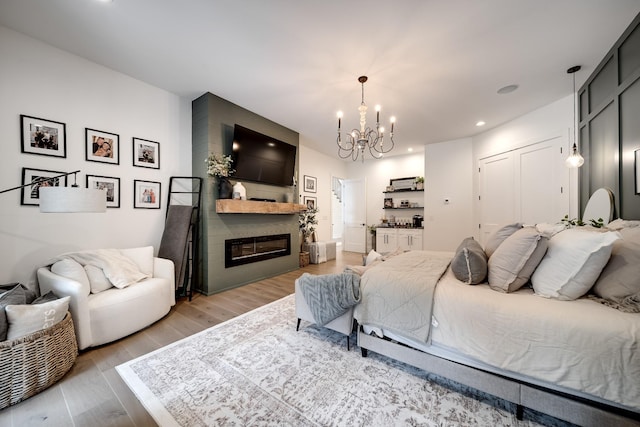 407 Hogans Branch Rd, Goodlettsville, TN 37072 - bedroom with a chandelier, light wood-style floors, a fireplace, a closet, and recessed lighting