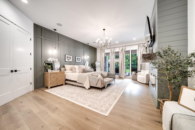 407 Hogans Branch Rd, Goodlettsville, TN 37072 - bedroom with a chandelier, light wood-style floors, a decorative wall, and recessed lighting