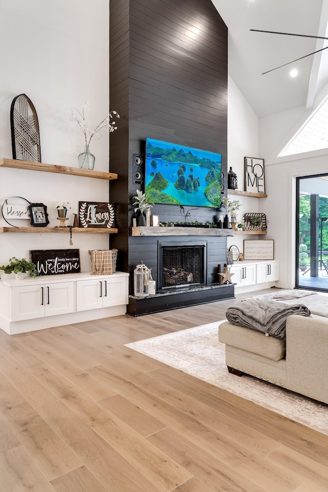 407 Hogans Branch Rd, Goodlettsville, TN 37072 - living area with high vaulted ceiling, a fireplace, light wood-type flooring, and recessed lighting