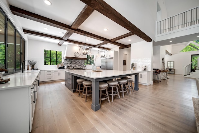 407 Hogans Branch Rd, Goodlettsville, TN 37072 - kitchen with stainless steel built in refrigerator, a sink, white cabinets, backsplash, and light countertops