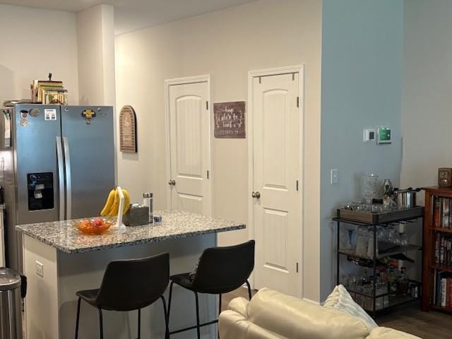 1217 Mason Dl, Columbia, TN 38401 - kitchen featuring light stone counters, a kitchen breakfast bar, stainless steel fridge, and a center island